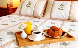 Breakfast on a bed in a hotel room